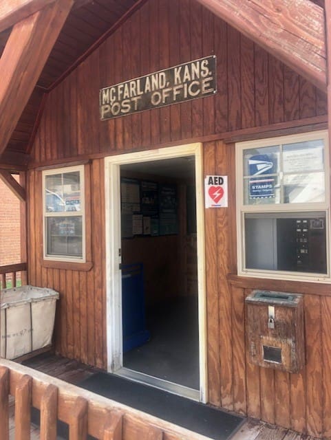 A door way to the post office with mail boxes.